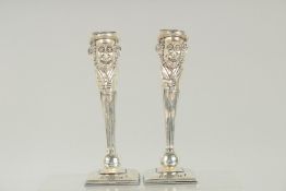 A PAIR OF SILVER PLATED JUDDICA MEN CANDLESTICKS. 6ins high.