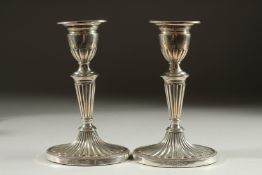 A PAIR OF SILVER CANDLESTICKS on oval bases. 6.5ins high. Sheffield 1910.