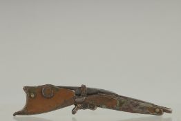 A SMALL FOLDING KNIFE as a gun by GESUTZLICH GESCHUETZT. 4.5ins long.