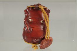 A LARGE CARVED HARDWOOD OCTOPUS INRO with rope and carp. 4ins