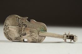 A CONTINENTAL SILVER CELLO repousse with figures. 4.5ins long.