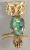 A SMALL GOLD OPAL SET OWL BROOCH.