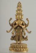 A GOOD GILT BRONZE MULTI HEAD DEITY set with beads. 11ins high.