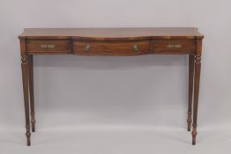 A REGENCY DESIGN MAHOGANY LONG SIDE TABLE with bow front, cross banded top, single frieze top on