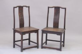 A PAIR OF CHINESE HARDWOOD CHAIRS with carved panel backs. 3ft 7ins high.