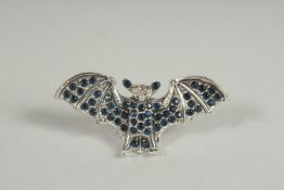 A SILVER SAPPHIRE AND DIAMOND BAT BROOCH.
