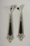 A PAIR OF SILVER ONYX ART DECO STYLE DROP EARRINGS.