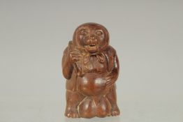 AN AMUSING CARVED WOOD BEAR FIGURE NETSUKE. Signed.