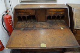 A GEORGE III OAK BUREAU with fall front over four long graduated drawers. 3ft 2ins wide.