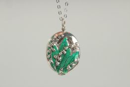 A SILVER AND GREEN ENAMEL LILY OF THE VALLEY LOCKET AND CHAIN.