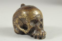 A RARE POSSIBLY 17TH CENTURY DUTCH BRASS POMANDER formed as a skull with fitted up lid. 2.5ins long,