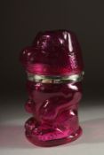 A CRANBERRY AND SILVER PLATED DOG CLARET JUG.