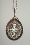 A SILVER AND OPAL SET LOCKET AND CHAIN.