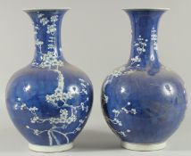 A PAIR OF CHINESE BLUE AND WHITE VASES, almond blossom. 14ins high.