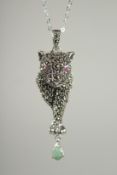 A SILVER RUBY, EMERALD, MARCASITE PANTHER PENDANT AND CHAIN.