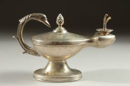 A SILVER ALADDIN'S LAMP TABLE LIGHTER with bird handle on an oval base. London 1908. Maker: I. B.