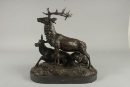 AFTER P. J. MENE A BRONZE STAG, DOE AND DOG on a marble base. Signed. 14ins high.
