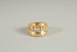 AN 18CT GOLD RING set with twelve diamonds.