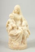 A GOOD 18TH - 19TH CENTURY CARVED MARBLE FAMILY GROUP mother and two children on a circular base.