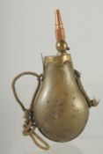 A RARE RHINO HORN POWDER FLASK with rope and brass fittings. 9.5ins long