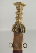 A GERMAN SWORD in a leather scabbard with brass handle. 34ins long.