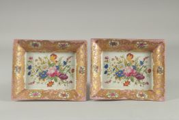 A PAIR OF SEVRES DESIGN PINK TRAYS with flowers on gilt bases. 7.5ins x 6ins.