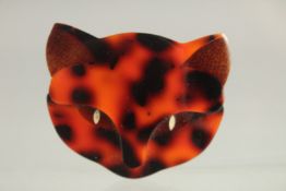 A LEA STERN OF PARIS ORANGE AND BLACK CAT'S FACE BROOCH with mother of pearl eyes.