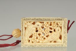 A CARVED AND PIERCED BONE PENDANT. 1.75ins.