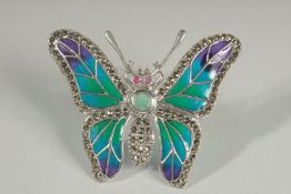 A SILVER PLIQUE A JOUR EMERALD BUTTERFLY BROOCH.
