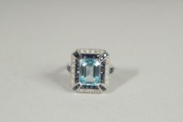 A 9CT GOLD BLUE TOPAZ, SAPPHIRE AND DIAMOND ART DECO STYLE RING.