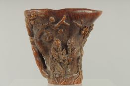 A SMALL CARVED LIBATION CUP carved with birch and foliage. 4.5ins high, 4.75ins wide overall.