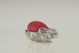 A NOVELTY SILVER RABBIT PIN CUSHION. 1.25ins long.