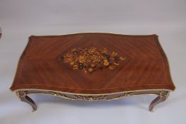 A LOUIS XVITH STYLE MAHOGANY INLAID COFFEE TABLE with floral crossbanded legs on curving legs. 4ft
