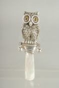 A SILVER AND MOTHER OF PEARL RATTLE. 3.25ins long.