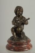 19TH CENTURY FRENCH. A SMALL BRONZE OF A BOY playing a mandolin on a circular marble base. 6ins