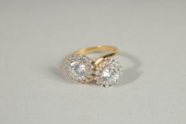 A SILVER, GOLD PLATED DOUBLE ZIRCONIA CLUSTER RING.
