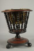 A DUTCH MAHOGANY CIRCULAR BUCKET on a circular base with brass liner.