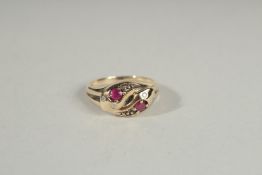 A 9CT GOLD RUBY AND DIAMOND SNAKE RING.