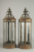 A PAIR OF COPPER AND GLASS CIRCULAR LANTERNS.