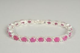 A SILVER RUBY SET LINE BRACELET.
