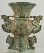 AN ARCHAIC CARVED JADE VASE carved with dragons. 7.25ins high.