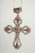 A SILVER GILT RUBY SET CROSS AND CHAIN.
