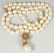 A VERY GOOD CHANEL LONG, LARGE PEARL NECKLACE, sixty six pearls with enamel pendant and large pearl.
