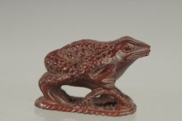 A JAPANESE CARVED WOOD FROG NETSUKE. Signed 2ins.