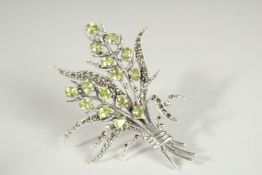 A SILVER PERIDOT FLORAL SPRAY BROOCH.