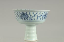 A CHINESE BLUE AND WHITE CIRCULAR STEM CUP. The inside with a man. 4.5ins diameter.