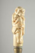 A BONE HANDLE WALKING STICK 'MONKEYS'.