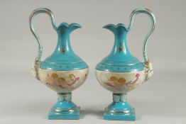 A PAIR OF SEVRES DESIGN PORCELAIN JUGS with a band of cupids. 13ins high.