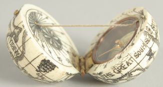 AN ETCHED BONE GLOBE COMPASS.