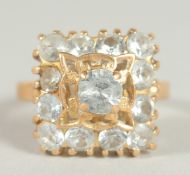 A GOOD 18CT GOLD AQUAMARINE SET SQUARE, CLUSTER RING.